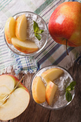 Chia seed pudding and apples in a glass closeup. vertical top view