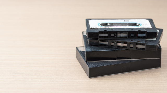 Close up vintage hi-end audio cassette tape on wooden table.