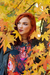 Naklejka na ściany i meble beautiful redhead girl in autumn scene