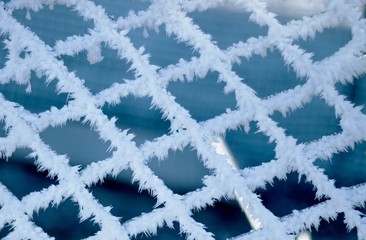 Frozen winter grille with ice needles