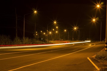 Night Road at suburban with the light trails car 