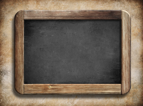 old vintage blackboard with wooden frame on grunge background