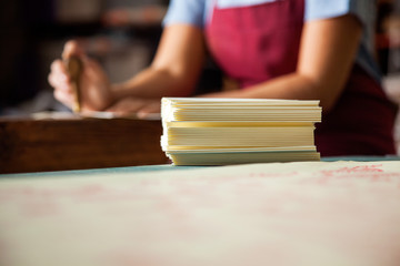 Papers On Table With Female Worker Working In Background