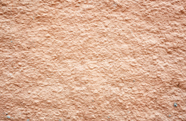 Vibrant orange brown grungy wall texture.