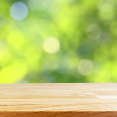 wood table and blurry green nature in background