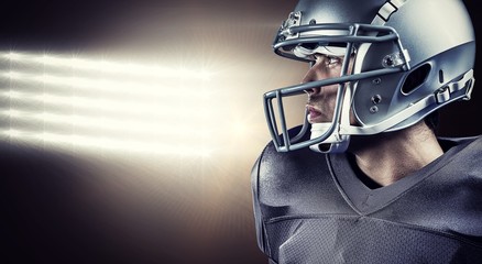 Composite image of sportsman with helmet looking away