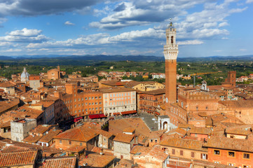 Siena, Italy rooftop city panorama. Mangia Tower, Italian Torre del Mangia