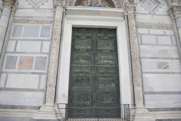 Fototapeta na wymiar Door and Facade of Cathedral Church in Pisa