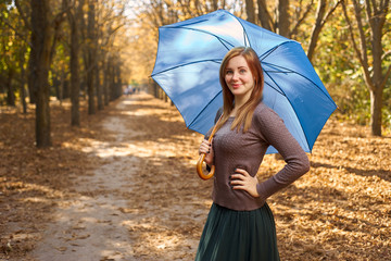 woman with an umbrella in the autumn park