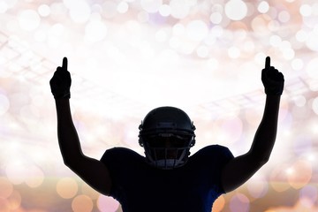 Composite image of silhouette american football player