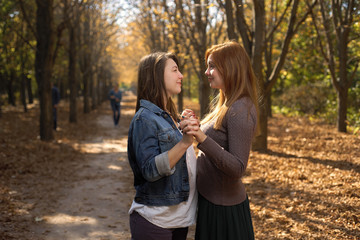 Two friends hugging in the park