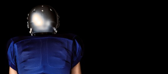 Fototapeta na wymiar Composite image of rear view of american football player