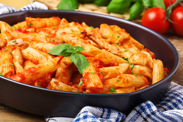 Fototapeta premium Penne with roasted chicken in tomato sauce