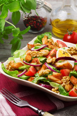 Delicious salad with chicken, nuts, egg and vegetables.