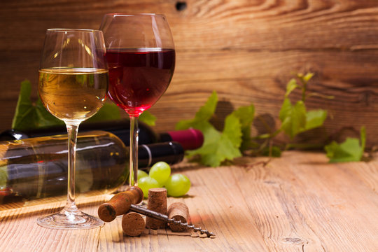 Glasses of red and white wine, served with grapes