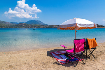 Umbrella and sundecks on beach, Greece