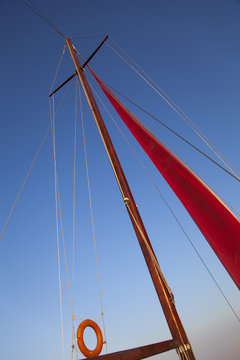 Image of a yacht mast and rigging during sailing in the sea. 