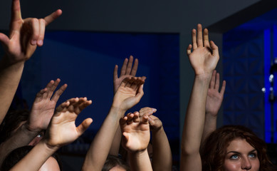 close up of happy people at concert in night club