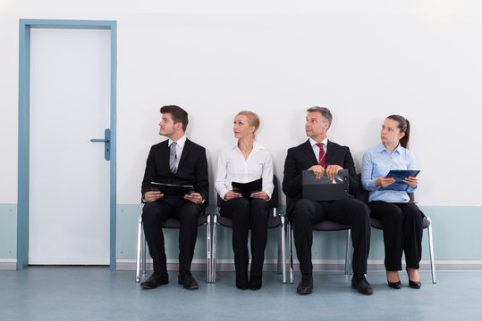 Businesspeople Sitting On Chair For Giving Interview