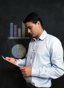 Businessman with tablet checking finacials, male with tablet on
