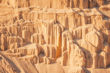Sand cliffs in industrial quarry background