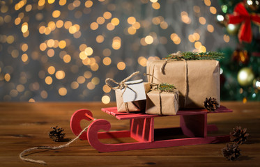 close up of christmas gift boxes on wooden sleigh