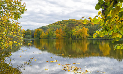 Fototapeta na wymiar on the shore of a lake in autumn