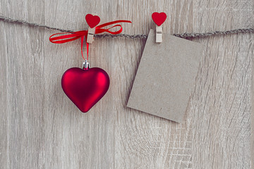 Fototapeta premium Christmas decorations with a blank card hanging over wooden back