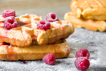 Waffles with raspberries and strawberry syrup