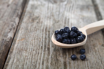 Ripe blackberries in a wooden spoon