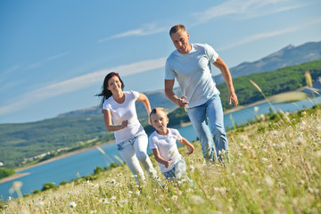 Happy family in a camomile field 