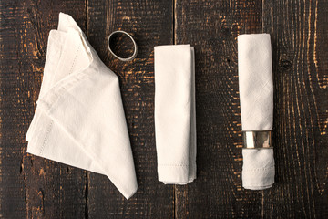 Set of the napkins with vintage ring on the wooden table