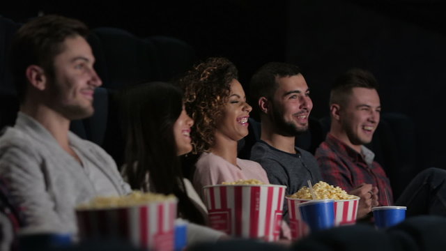 Friends in cinema watching a movie