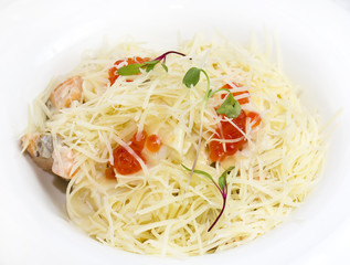 spaghetti with eggs decorated with greenery on a white background