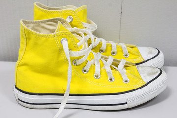 yellow shoes on a wooden floor