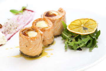 fried fish rolls with herbs on a white plate