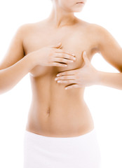 Fototapeta premium Woman examining her breast isolated on white background 