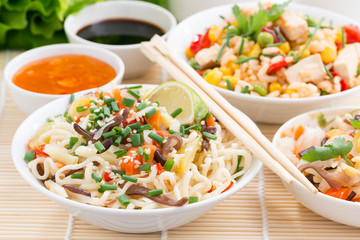 Asian food - noodles with vegetables and greens, fried rice 