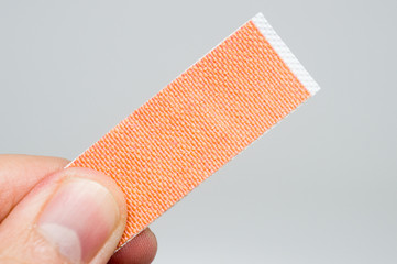 adhesive sticking bandage plaster on isolated grey background