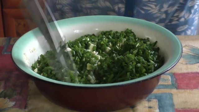 A woman prepares filling for pies