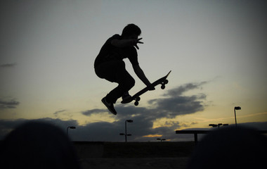 A skateboarder skates in a skate park.