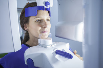 A dental X-Ray scanner scanning a woman - 94222956