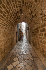 Fototapeta na wymiar Narrow street and tunnel in the Old Town in Dubrovnik, Croatia 