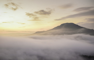 Fototapeta premium Bright saturated color dawn above the sea of fog over the mountain