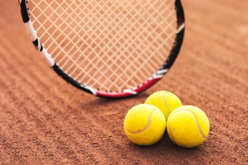 Close up of tennis balls and racquet