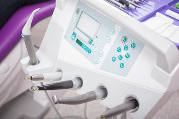 Fototapeta na wymiar Different dental instruments over patient sitting in a purple de