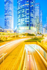 Fototapeta na wymiar Traffic light at night and Business center building at Hong kong