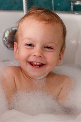 Happy baby in bathroom foam