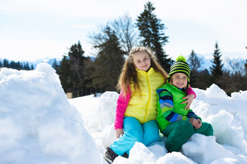 Fototapeta na wymiar Smiling children playing with snow