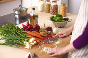 Young Woman Cooking in the kitchen. Healthy Food
